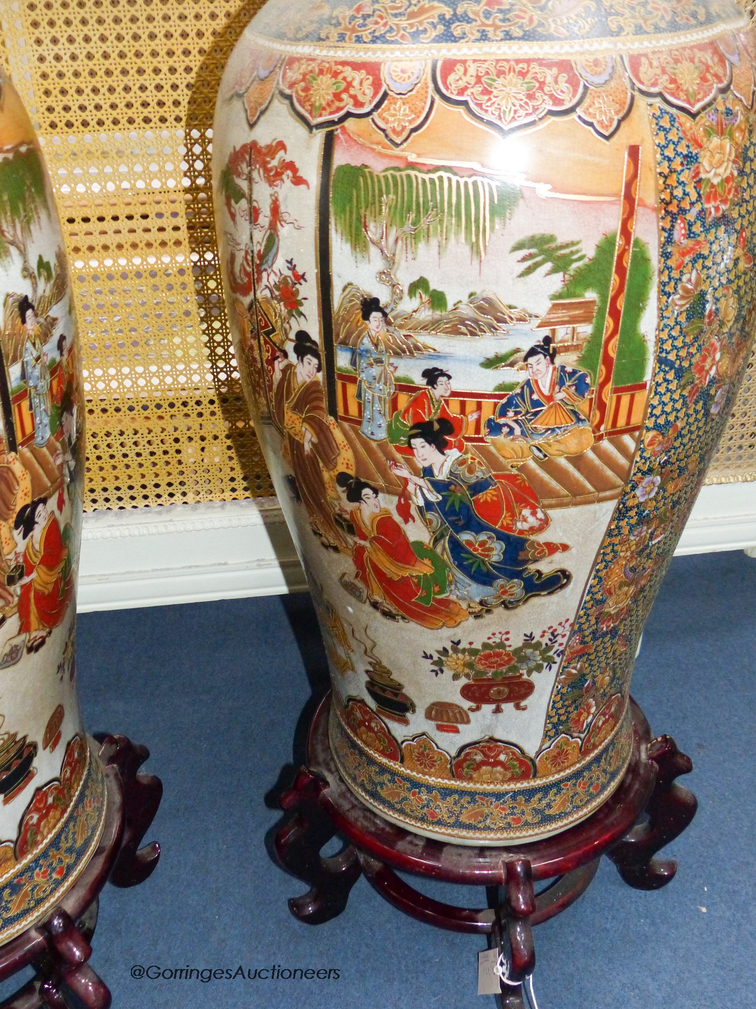 A pair of large Japanese vases, on hardwood stands